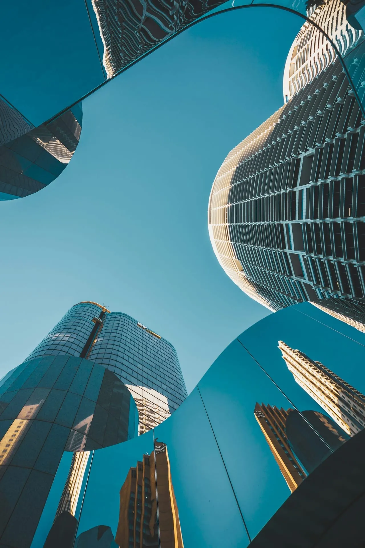 Mirrored glass skyscrapers upward reflections