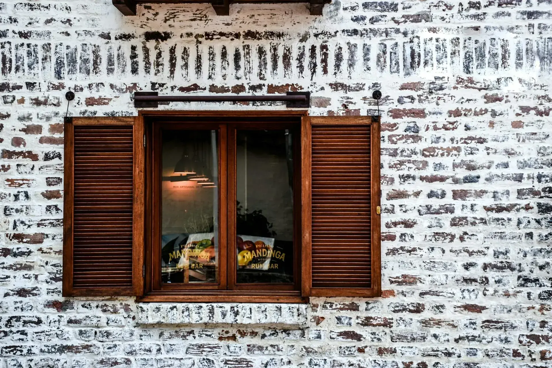 Whitewashed brick wall wooden shutters