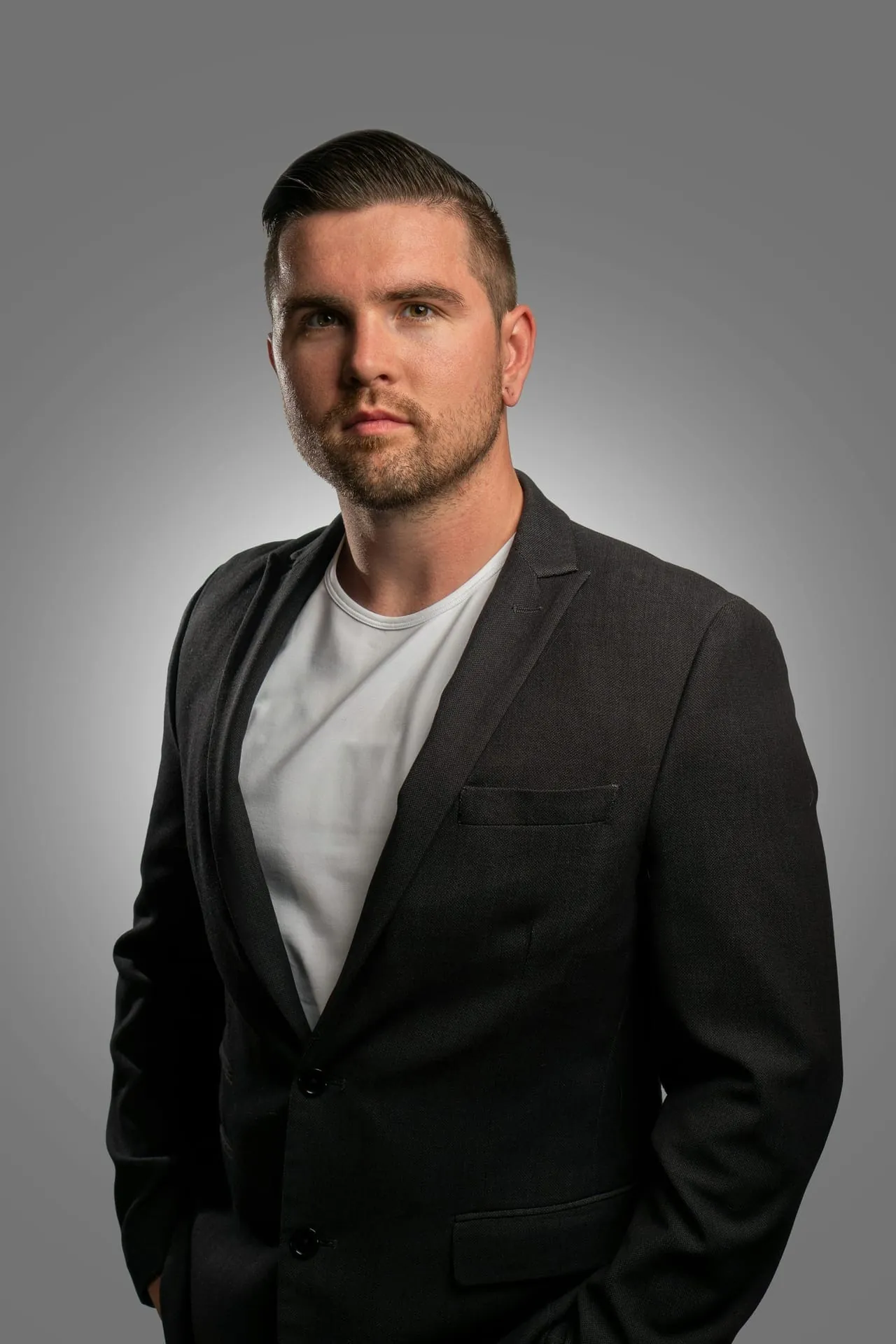 Professional man headshot dark blazer vignette
