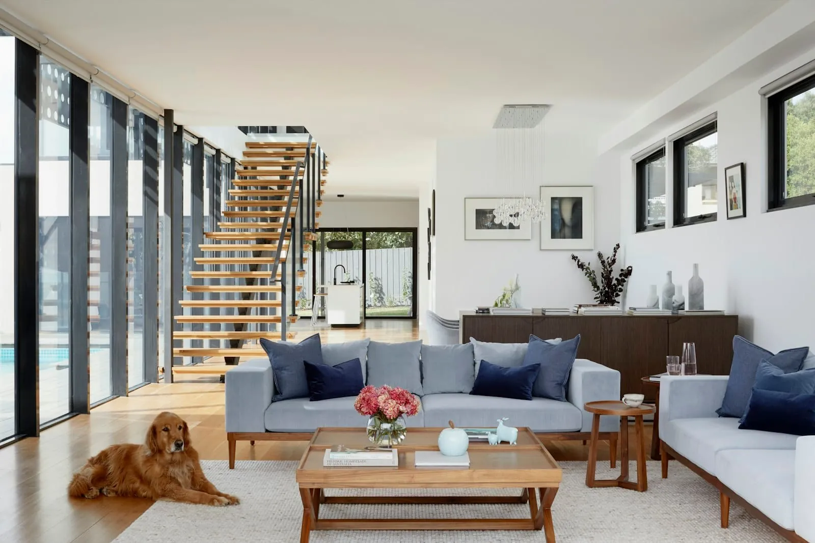 Real estate interior living room floating staircase dog