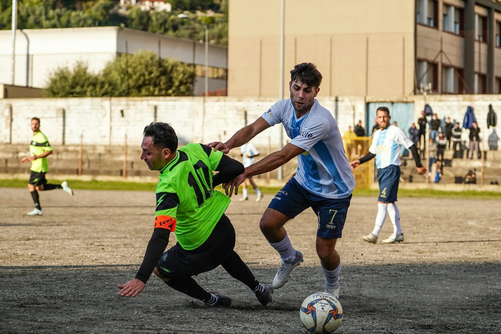 Soccer tackle duel dirt pitch action