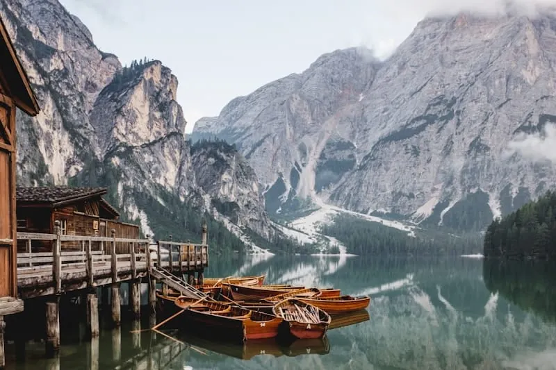Rowboats dolomites alpine lake reflection
